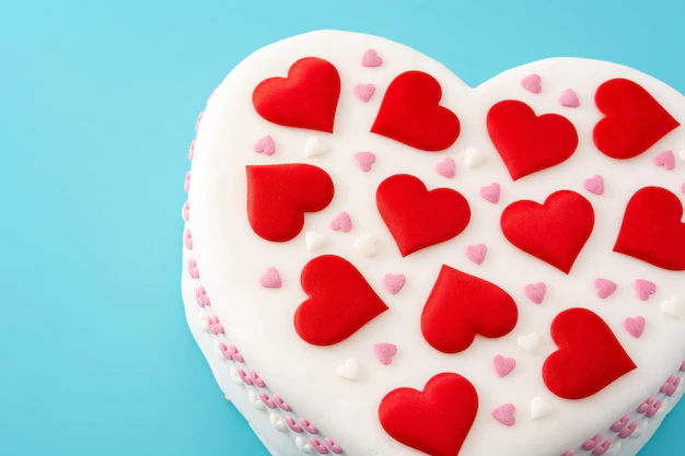 heart-cake-st-valentine-s-day-decorated-with-sugar-hearts-blue-background_123827-16560